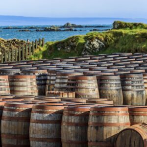 Scotch whisky barrels lined up seaside on the Island of Islay, Scotland UK