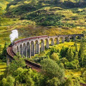 Glenfinnan Railway Viaduct in Scotland with the Jacobite steam train passing over